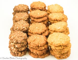 A picture of Anzac Biscuits made three ways. With golden syrup, molasses and corn syrup
