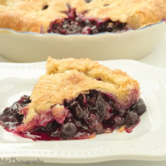 A picture of a slice of homemade Blueberry Pie.