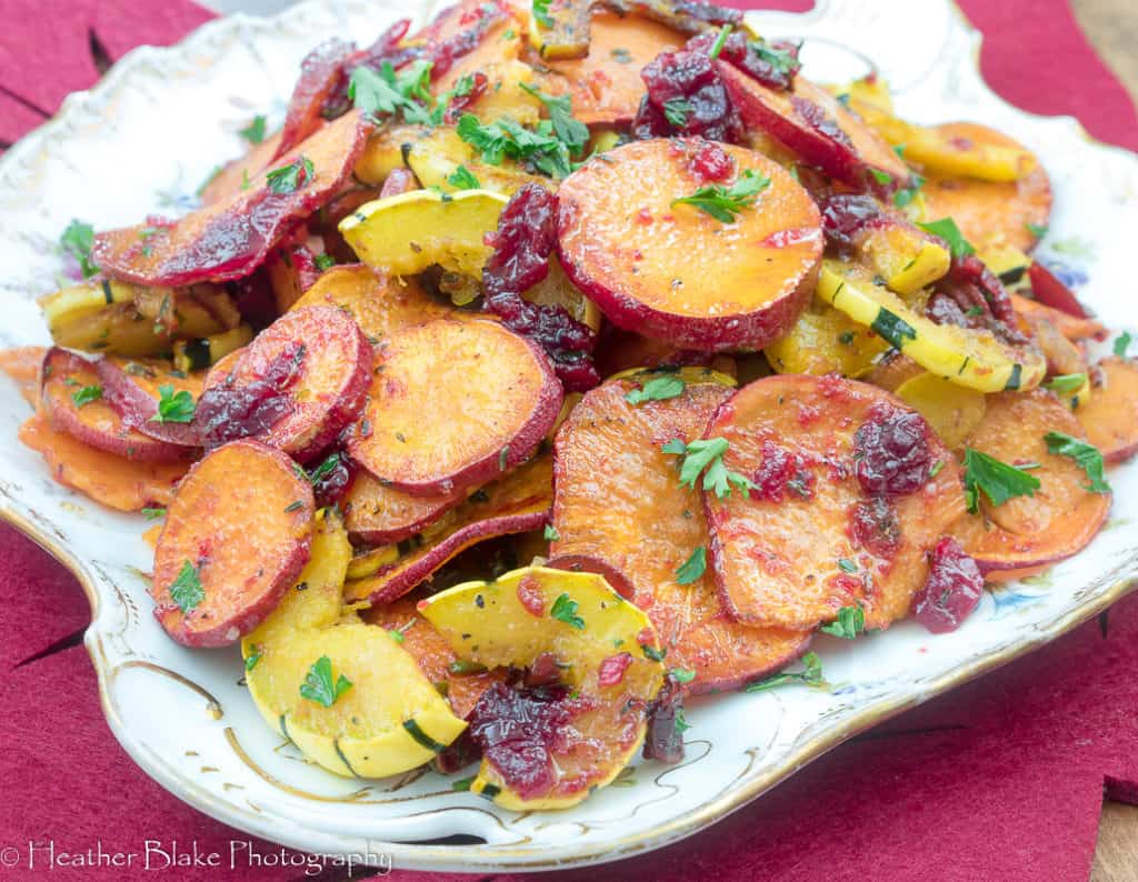 A picture of Roasted Squash and Sweet Potatoes with Cranberries on a plate ready for Service.