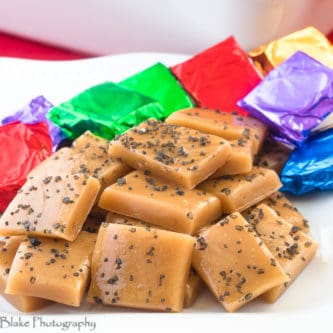 A picture of black sea salt caramels sliced and ready to wrapped in colorful tinfoil.